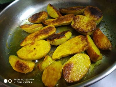 Golden roasted plantains cooking in a skillet, perfect for a savory snack or side dish.