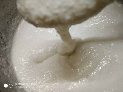 Creamy coconut milk being poured, showcasing delicious content for recipes or food stories.