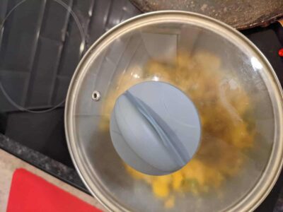 Boiling ingredients in a stainless steel pot on stove, capturing a close-up view.