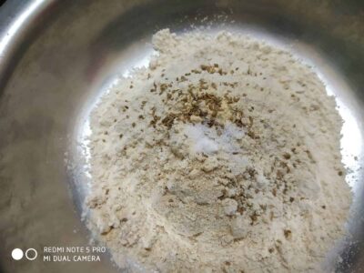 Flour mixture with spices in a mixing bowl for cooking or baking.