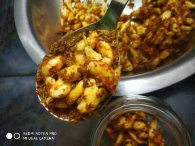 Savory spicy chicken curry served in a silver bowl with a spoon for serving.