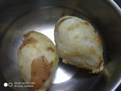 Boiled sweet potatoes in a stainless steel bowl, showcasing a healthy and nutritious snack option.