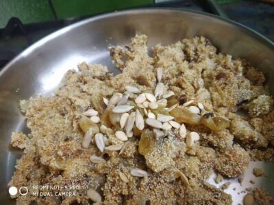 Crunchy sweet jaggery ladoos with sesame seeds and chopped nuts, traditional Indian festive snacks.