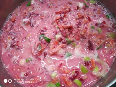 Creamy tomato and vegetable soup with herbs, served hot and rich in flavor.