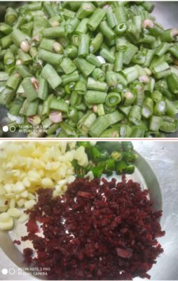 Chopped green beans, garlic, ginger, and dried red chilies on a stainless steel plate, ready for cooking.