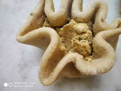 Golden fried snack with a crunchy texture and sprinkled with spices.
