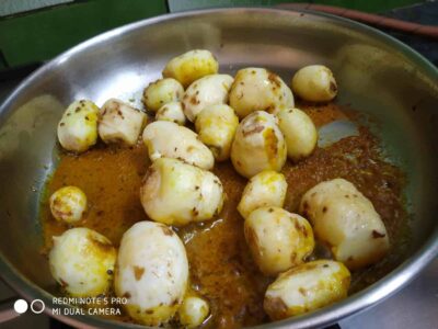 Boiled matar or green peas cooking in spiced gravy, traditional Indian dish preparation.