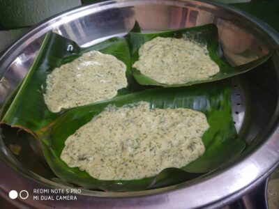 Delicious traditional Indian snack batter on banana leaves in a steaming tray.