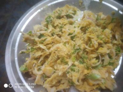 Scrambled egg with vegetables on a silver plate, close-up view.